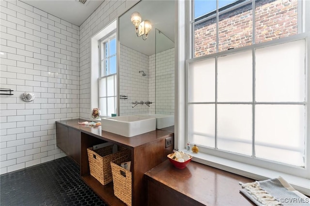 2417 E Grace St, Richmond, VA 23223 - bathroom with tile walls, tile patterned floors, and vanity