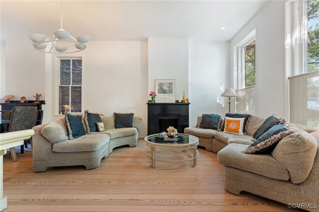 2417 E Grace St, Richmond, VA 23223 - living area with wood finished floors, a chandelier, a fireplace, and recessed lighting