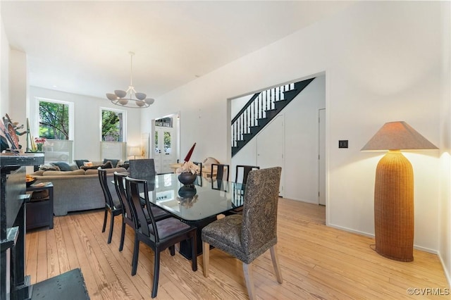 2417 E Grace St, Richmond, VA 23223 - dining room with light wood-style floors, stairs, and a chandelier