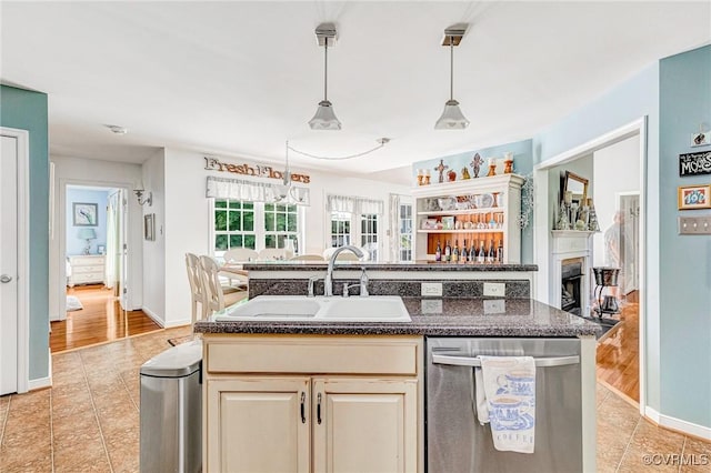 10151 W Providence Rd, North Chesterfield, VA 23236 - kitchen with stainless steel dishwasher, light tile patterned floors, pendant lighting, and a center island with sink