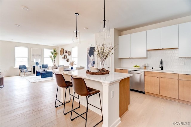 3446 Carlton St Unit 6-8A, Richmond, VA 23230 - kitchen featuring dishwasher, a breakfast bar, light wood-style floors, and light countertops