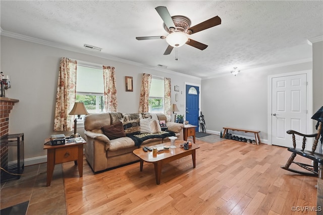 99 Oak Hill Rd, Cumberland, VA 23040 - living area featuring ceiling fan, light wood finished floors, a textured ceiling, ornamental molding, and a fireplace