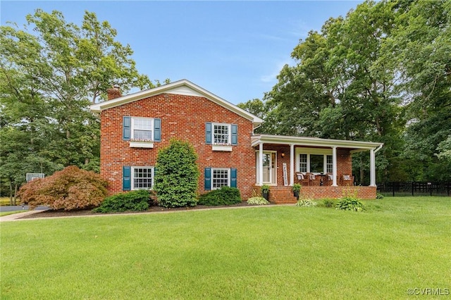 9065 Greenlake Cir, Mechanicsville, VA 23116 - split level home with a chimney, brick siding, and a porch