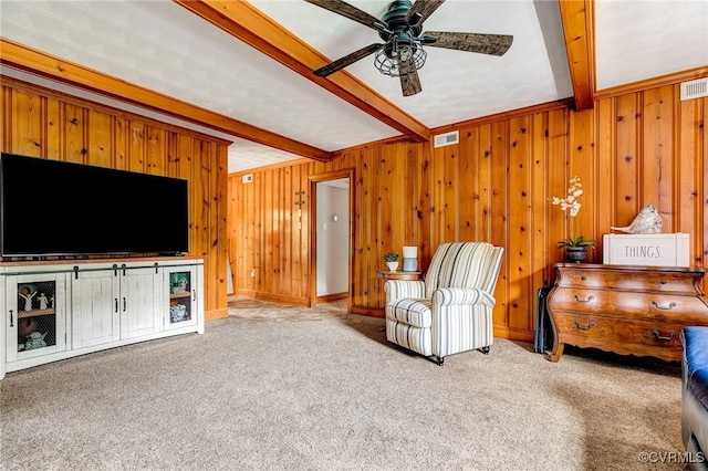 9065 Greenlake Cir, Mechanicsville, VA 23116 - living area featuring beamed ceiling, ceiling fan, carpet flooring, and wood walls