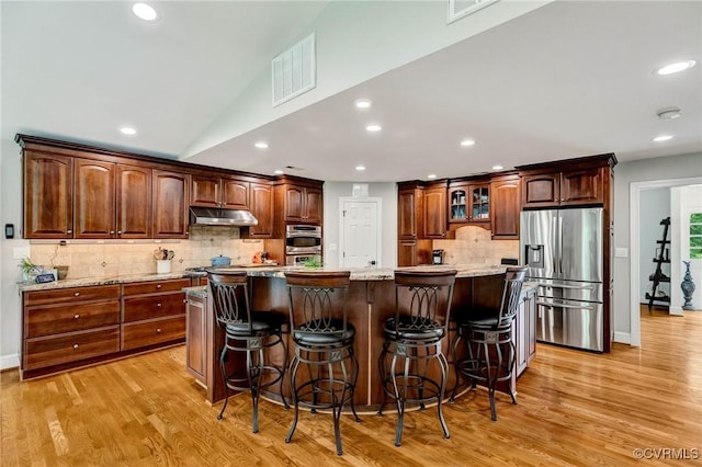 9065 Greenlake Cir, Mechanicsville, VA 23116 - kitchen with stainless steel fridge, light wood-style flooring, decorative backsplash, under cabinet range hood, and recessed lighting