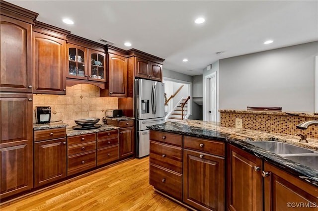 9065 Greenlake Cir, Mechanicsville, VA 23116 - kitchen featuring stainless steel refrigerator with ice dispenser, light wood-style floors, recessed lighting, backsplash, and dark stone counters