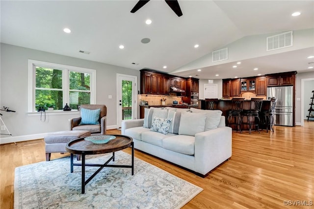 9065 Greenlake Cir, Mechanicsville, VA 23116 - living area featuring a ceiling fan, vaulted ceiling, light wood-style floors, recessed lighting, and bar