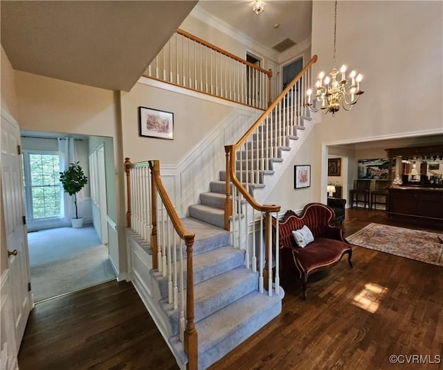 10278 Henderson Hall Rd, Mechanicsville, VA 20116 - stairway featuring wood finished floors, a towering ceiling, a chandelier, and crown molding