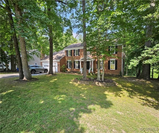10278 Henderson Hall Rd, Mechanicsville, VA 20116 - colonial house with an attached garage, brick siding, a front lawn, and asphalt driveway