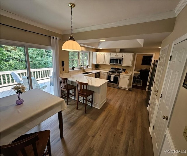 10278 Henderson Hall Rd, Mechanicsville, VA 20116 - kitchen with appliances with stainless steel finishes, a peninsula, white cabinets, dark wood-type flooring, and ornamental molding