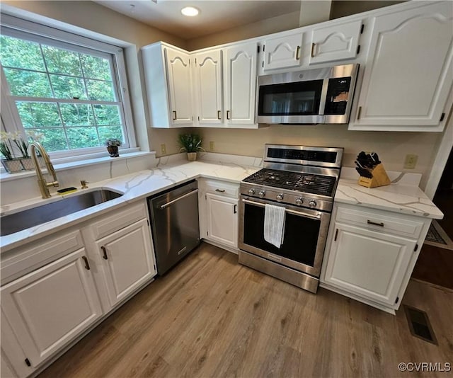 10278 Henderson Hall Rd, Mechanicsville, VA 20116 - kitchen with appliances with stainless steel finishes, white cabinetry, wood finished floors, and recessed lighting