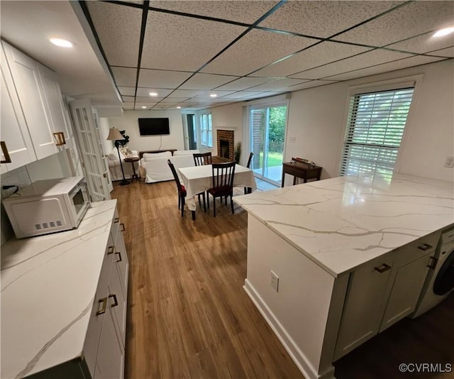 10278 Henderson Hall Rd, Mechanicsville, VA 20116 - kitchen with white microwave, dark wood-style flooring, light stone counters, white cabinetry, and open floor plan