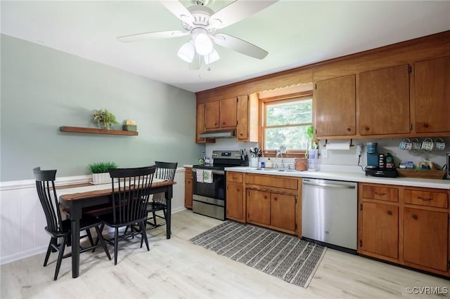 2000 Point Of Rocks Rd, Chester, VA 23836 - kitchen featuring stainless steel appliances, under cabinet range hood, light wood finished floors, light countertops, and brown cabinets