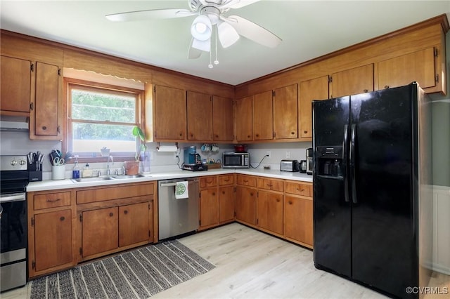 2000 Point Of Rocks Rd, Chester, VA 23836 - kitchen featuring appliances with stainless steel finishes, extractor fan, brown cabinetry, and light wood finished floors