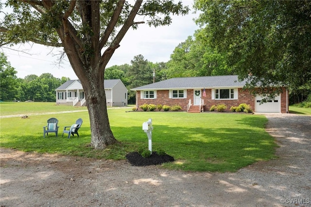 2000 Point Of Rocks Rd, Chester, VA 23836 - ranch-style home with dirt driveway, a garage, brick siding, and a front lawn