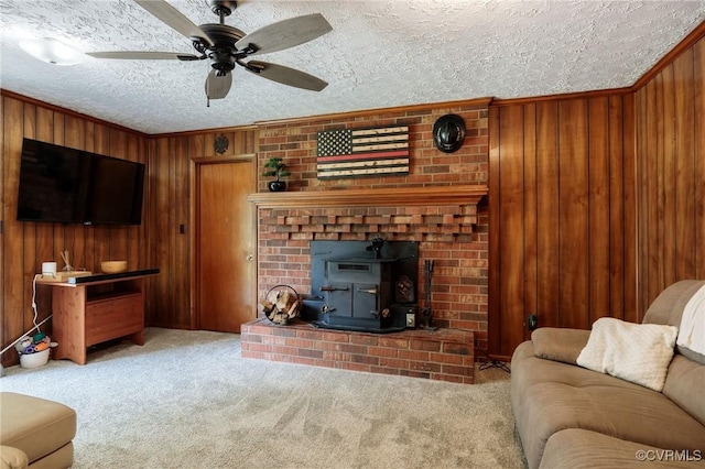 2000 Point Of Rocks Rd, Chester, VA 23836 - living room with carpet, ceiling fan, wood walls, a textured ceiling, and a wood stove