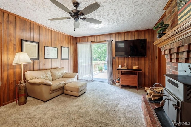2000 Point Of Rocks Rd, Chester, VA 23836 - living area with wood walls, carpet, crown molding, a ceiling fan, and a textured ceiling