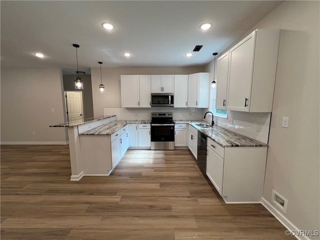 8104 Strath Rd, Henrico, VA 23231 - kitchen featuring appliances with stainless steel finishes, a peninsula, light stone counters, white cabinetry, and recessed lighting
