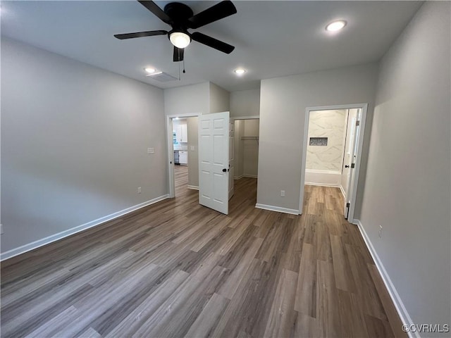 8104 Strath Rd, Henrico, VA 23231 - unfurnished bedroom with wood finished floors, a spacious closet, ceiling fan, ensuite bathroom, and a closet
