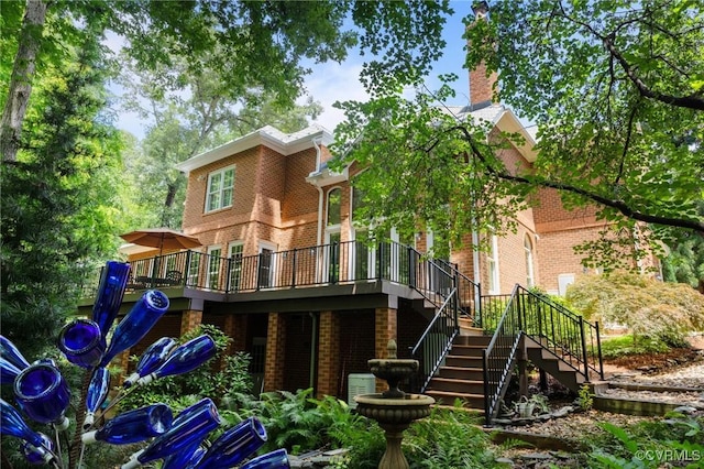 9261 Royal Grant Dr, Hanover, VA 23116 - back of property with brick siding, stairway, a deck, and a chimney