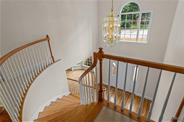9261 Royal Grant Dr, Hanover, VA 23116 - staircase featuring plenty of natural light, a chandelier, and wood finished floors