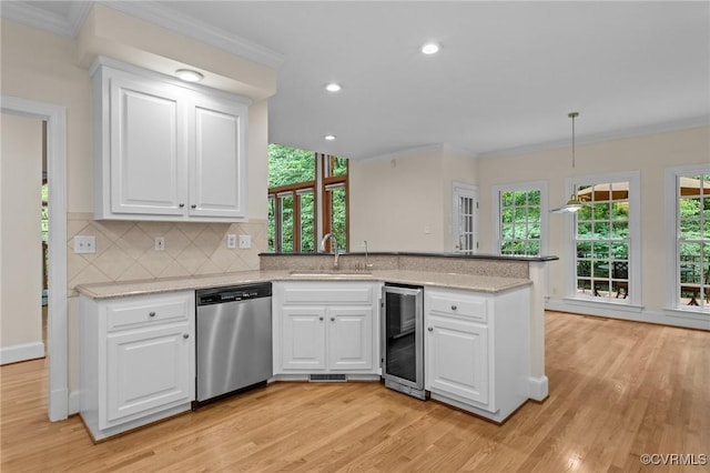 9261 Royal Grant Dr, Hanover, VA 23116 - kitchen with dishwasher, beverage cooler, a peninsula, ornamental molding, and light wood-type flooring