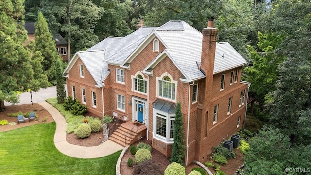 9261 Royal Grant Dr, Hanover, VA 23116 - view of front of house featuring a chimney, brick siding, a front lawn, and view of scattered trees