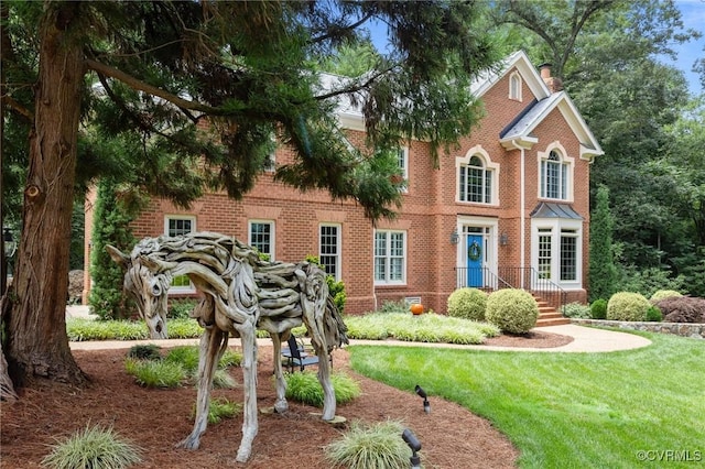 9261 Royal Grant Dr, Hanover, VA 23116 - view of front of house featuring a chimney, brick siding, and a front yard