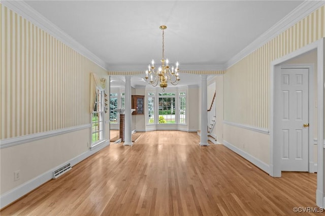 9261 Royal Grant Dr, Hanover, VA 23116 - unfurnished dining area featuring wood finished floors, ornamental molding, stairs, a chandelier, and decorative columns