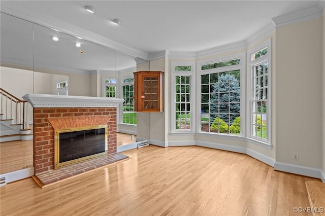 9261 Royal Grant Dr, Hanover, VA 23116 - unfurnished living room with ornamental molding, wood finished floors, a fireplace, and stairway