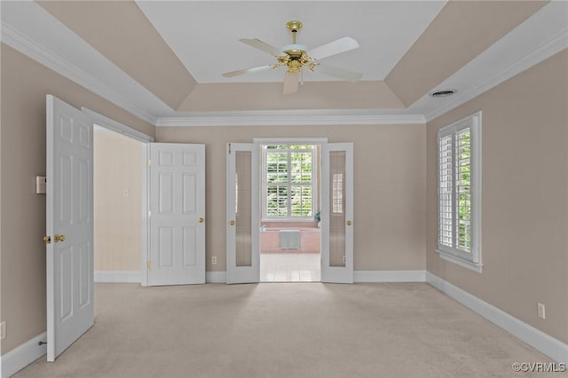 9261 Royal Grant Dr, Hanover, VA 23116 - spare room with a tray ceiling, plenty of natural light, light colored carpet, a ceiling fan, and crown molding