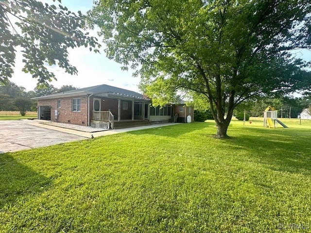 31368 Old Dawn Rd, Hanover, VA 23069 - view of green lawn featuring a playground, driveway, and a garage