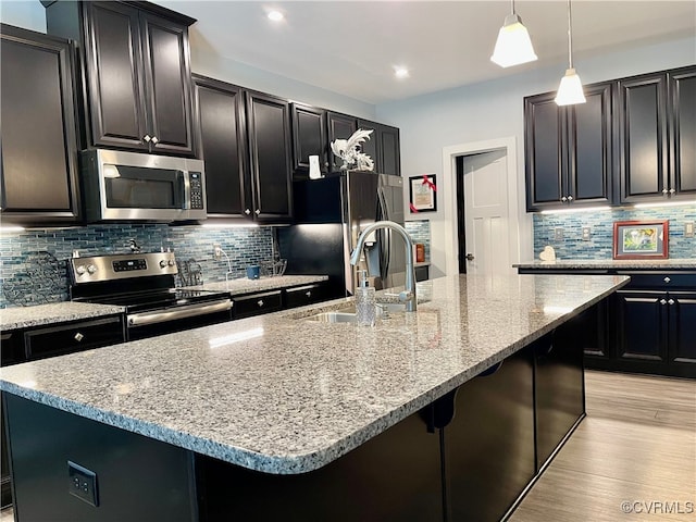 15518 Centerline Ct, Chesterfield, VA 23832 - kitchen featuring stainless steel appliances, dark cabinetry, backsplash, light wood-type flooring, and recessed lighting