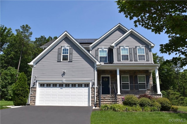 15518 Centerline Ct, Chesterfield, VA 23832 - view of front of home with stone siding, asphalt driveway, covered porch, and an attached garage