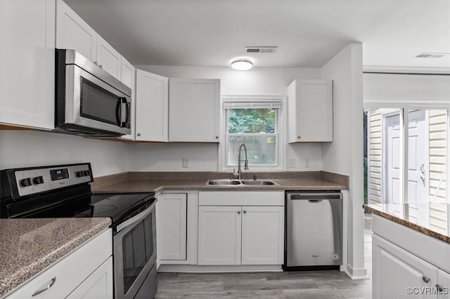 15241 Broadwater Cir, Chesterfield, VA 23831 - kitchen with stainless steel appliances, light wood-type flooring, and white cabinetry