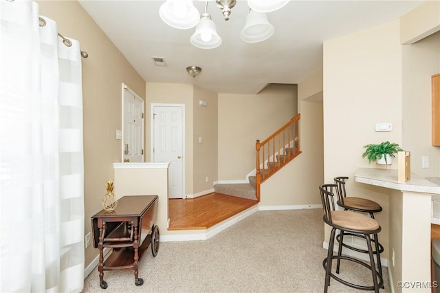 405 Hollybrook Ridge Ln, Richmond, VA 23223 - entrance foyer featuring carpet flooring, a chandelier, and stairs
