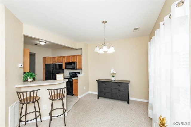 405 Hollybrook Ridge Ln, Richmond, VA 23223 - kitchen featuring black appliances, brown cabinetry, a chandelier, a breakfast bar, and light countertops