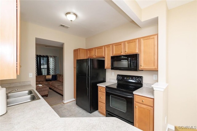 405 Hollybrook Ridge Ln, Richmond, VA 23223 - kitchen featuring black appliances, light brown cabinetry, light countertops, and light colored carpet