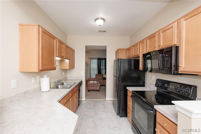 405 Hollybrook Ridge Ln, Richmond, VA 23223 - kitchen with black appliances, light brown cabinetry, light countertops, and light floors