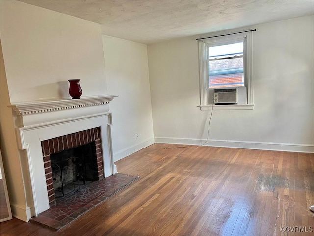 3305 Jeter Ave, Richmond, VA 23222 - unfurnished living room featuring cooling unit, hardwood / wood-style flooring, and a brick fireplace