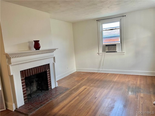 3305 Jeter Ave, Richmond, VA 23222 - unfurnished living room with cooling unit, wood-type flooring, and a brick fireplace