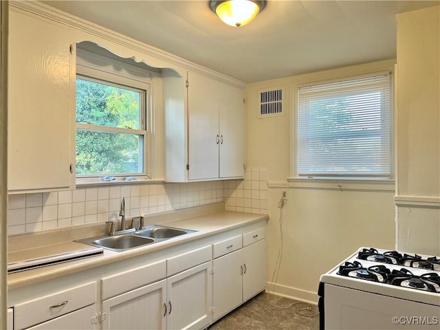 3305 Jeter Ave, Richmond, VA 23222 - kitchen with white cabinetry, light countertops, backsplash, and white range with gas cooktop