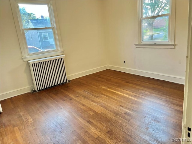 3305 Jeter Ave, Richmond, VA 23222 - empty room featuring radiator heating unit, hardwood / wood-style floors, and plenty of natural light