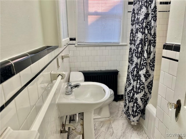 3305 Jeter Ave, Richmond, VA 23222 - full bathroom featuring tile walls, radiator, shower / bathtub combination with curtain, wainscoting, and marble finish flooring