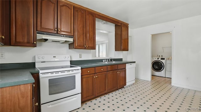 5500 Seminary Ave, Henrico, VA 23227 - kitchen featuring under cabinet range hood, white appliances, washer and dryer, light floors, and dark countertops
