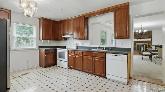 5500 Seminary Ave, Henrico, VA 23227 - kitchen featuring white appliances, a chandelier, under cabinet range hood, and dark countertops