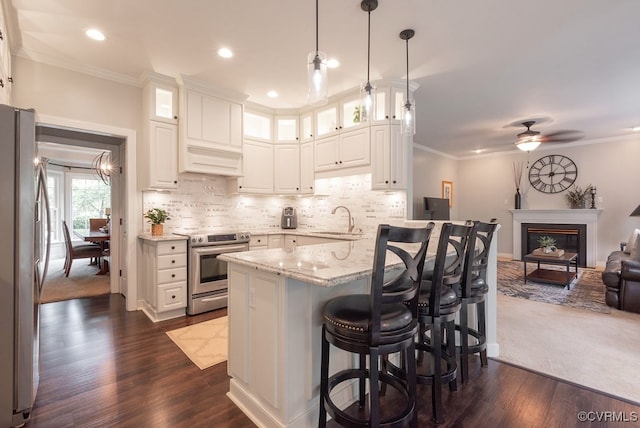 6013 Glen Abbey Dr, Glen Allen, VA 23059 - kitchen featuring appliances with stainless steel finishes, open floor plan, light stone counters, a kitchen bar, and white cabinetry