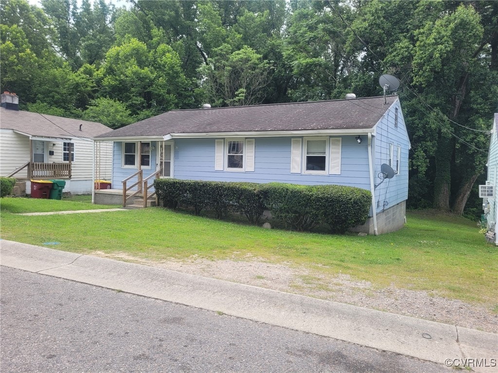 422 Walnut St, Petersburg, VA 23803 - view of front of house with a front lawn and roof with shingles