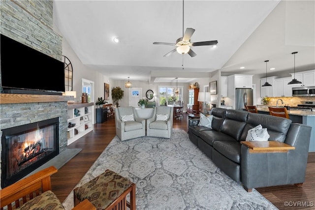 11561 Smokehouse Dr, Amelia Courthouse, VA 23002 - living room featuring ceiling fan, dark wood-type flooring, high vaulted ceiling, a stone fireplace, and recessed lighting