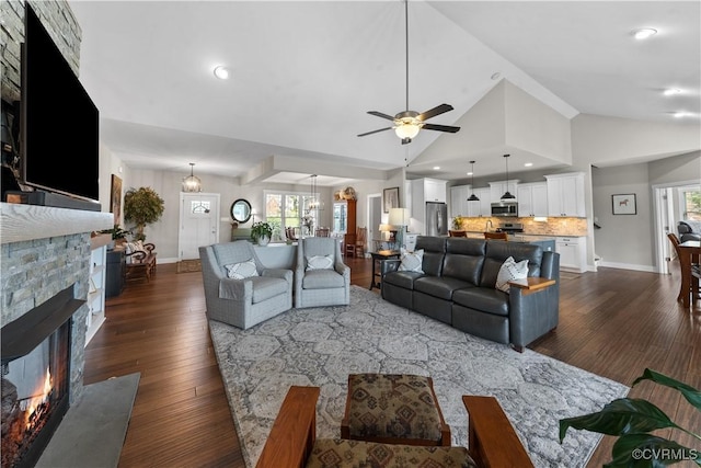 11561 Smokehouse Dr, Amelia Courthouse, VA 23002 - living area featuring dark wood-style flooring, a stone fireplace, ceiling fan, plenty of natural light, and high vaulted ceiling